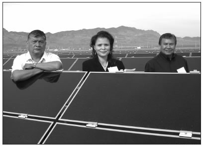 LARRY AHASTEEN, RAYOLA WERITO, AND JACK COLORADO POSING WITH SOLAR PANELS IN NEVADA