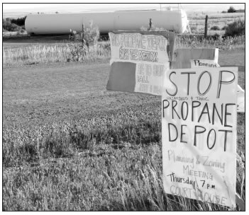 PROTEST SIGNS IN FRONT OF PROPANE STORAGE TANK NEAR THE SWANNER SUBDIVISION