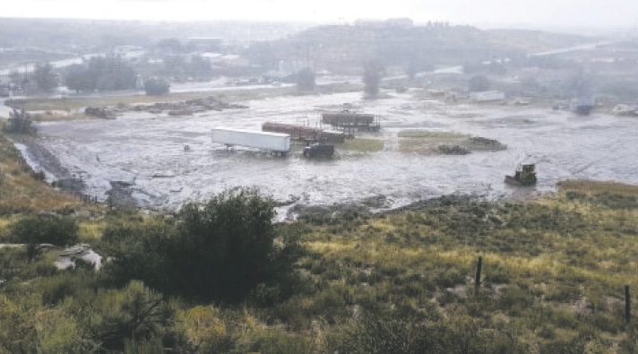 A deluge of rain in Cortez on Aug. 24 floods the area near the trailhead of the Carpenter Natural Area. An industrial use has been proposed for the 10-acre tract seen here from the top of a ridge.